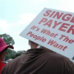 Person Holding a Sign that Says "Single Payer is What the People Want"